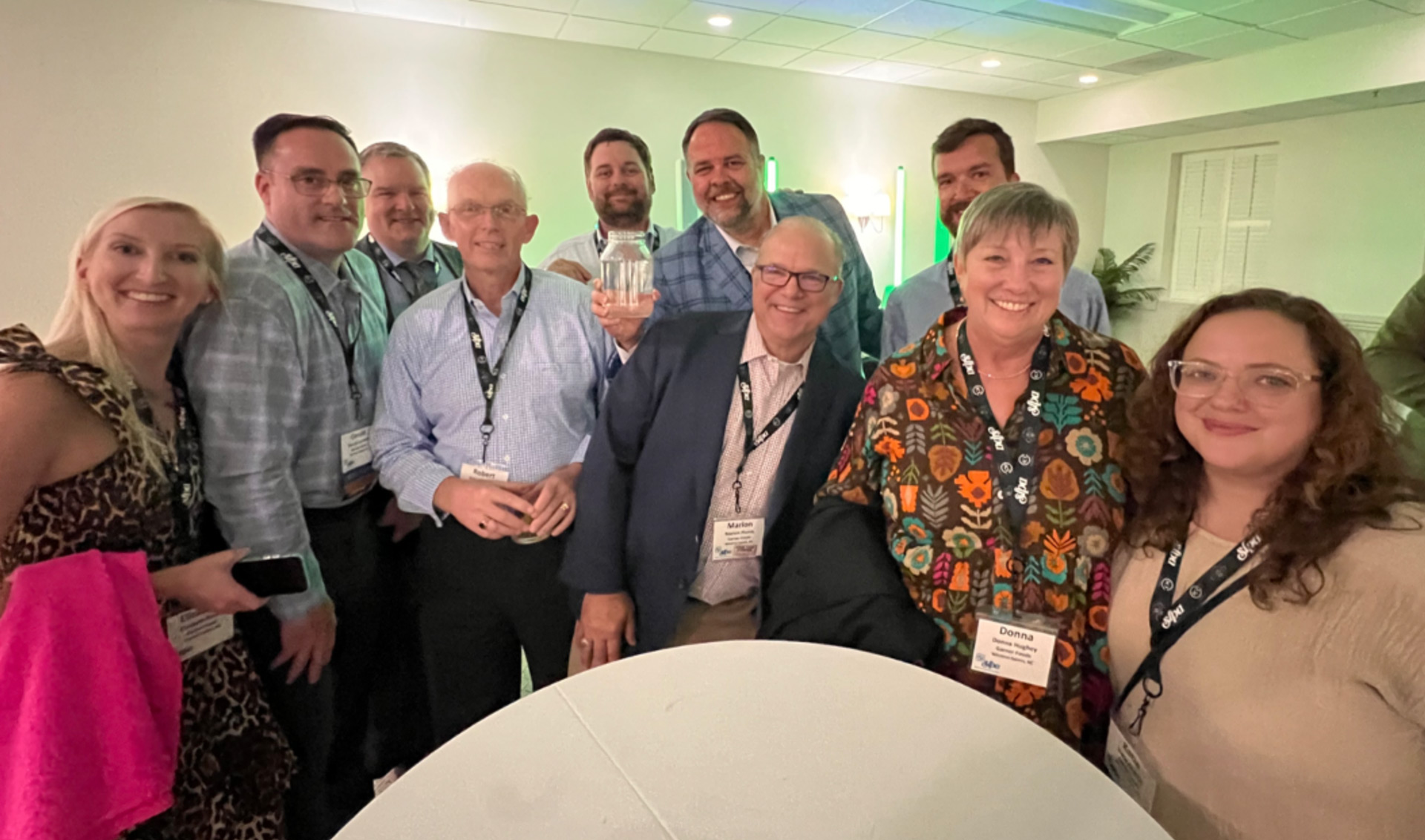 Garner Foods representatives gather to celebrate the winning bid in the moonshine raffle.